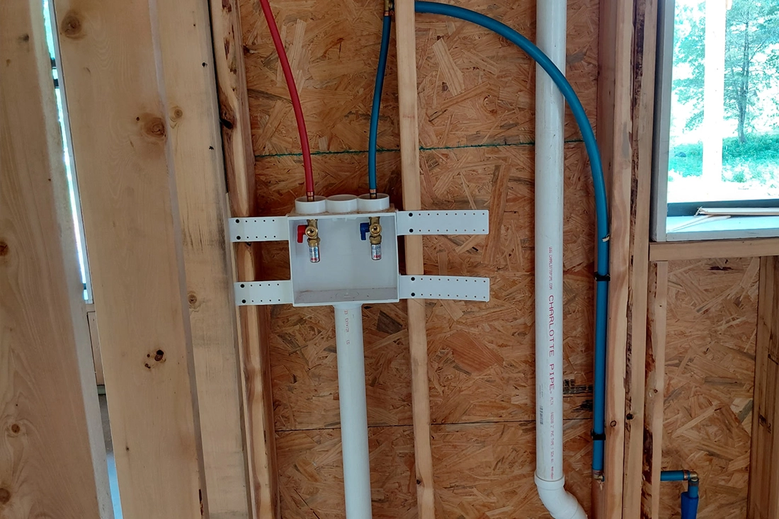 New construction plumbing rough-in — Shedd's Plumbing LLC Cullman County Washing machine outlet box with PEX supply lines roughed in for a new home in Cullman County, AL